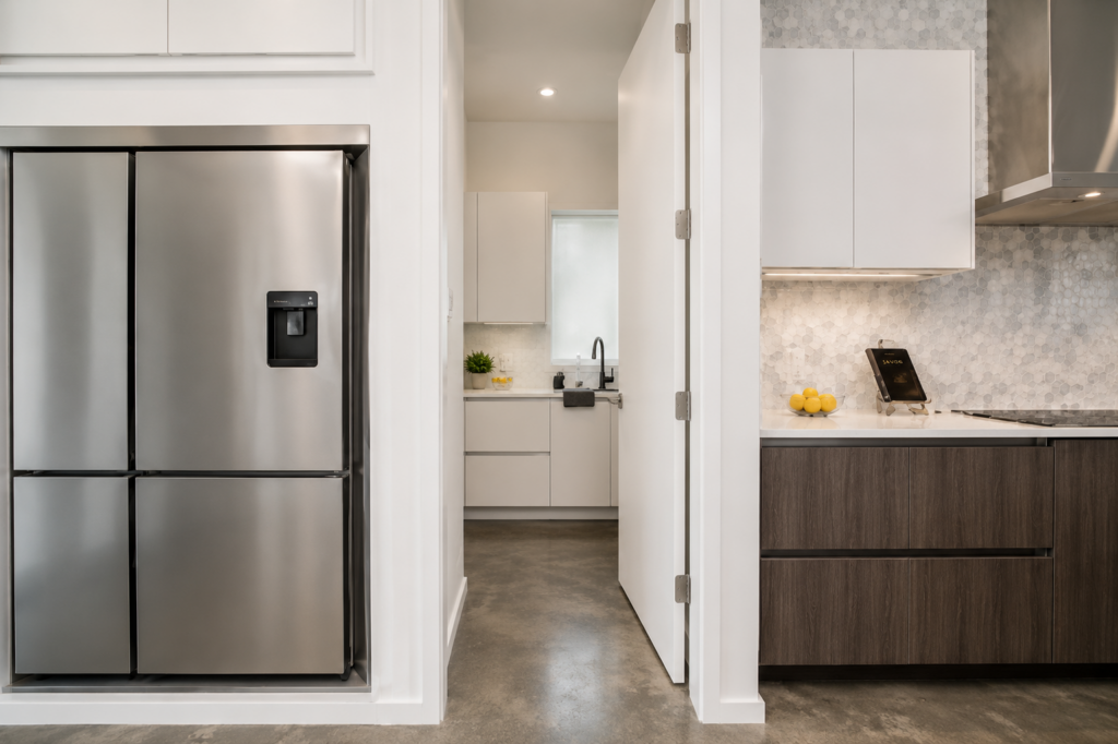 Urban Life kitchen with walk-in pantry, hexagon tile backsplash, and dark wood cabinetry by Posada Custom Homes in Orlando, FL
