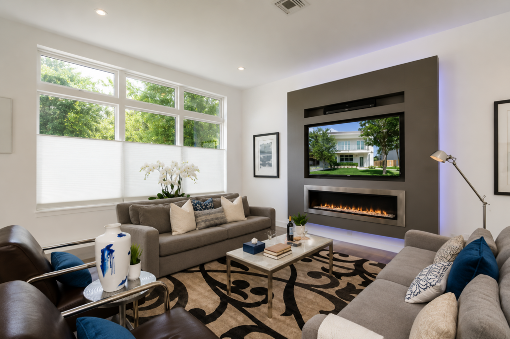 Urban Life living room with built-in media wall, linear fireplace with LED backlighting by Posada Custom Homes in Orlando, FL