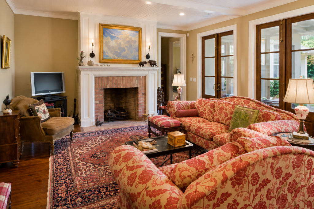 Urban Life Low Country living room with brick fireplace and beadboard ceiling by Posada Custom Homes in Orlando, FL