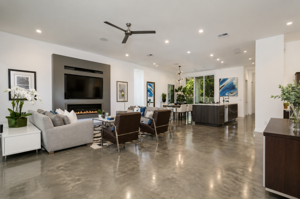 Urban Life open concept living room with linear gas fireplace and polished concrete floors by Posada Custom Homes in Orlando, FL
