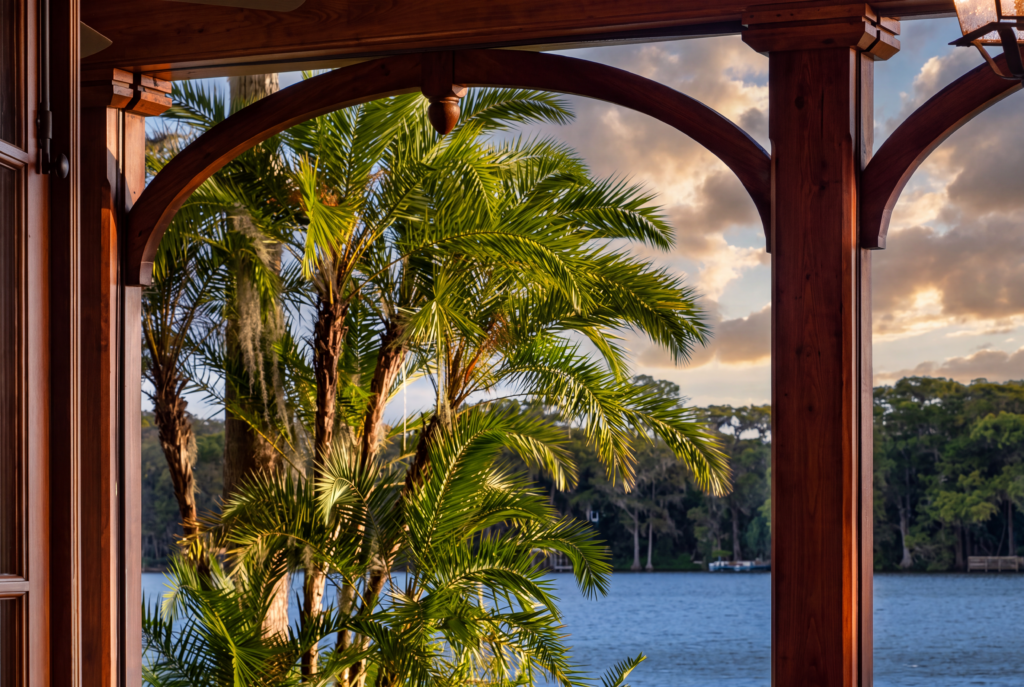 Lake view framed by an arched timber opening on the covered veranda